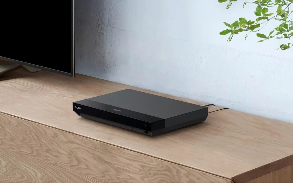 Sony UBP‑X700/K 4K Blu‑ray player placed on a dark table with a disc visible